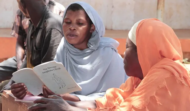 Parents looking at a Literacy book at Gopha Primary School
